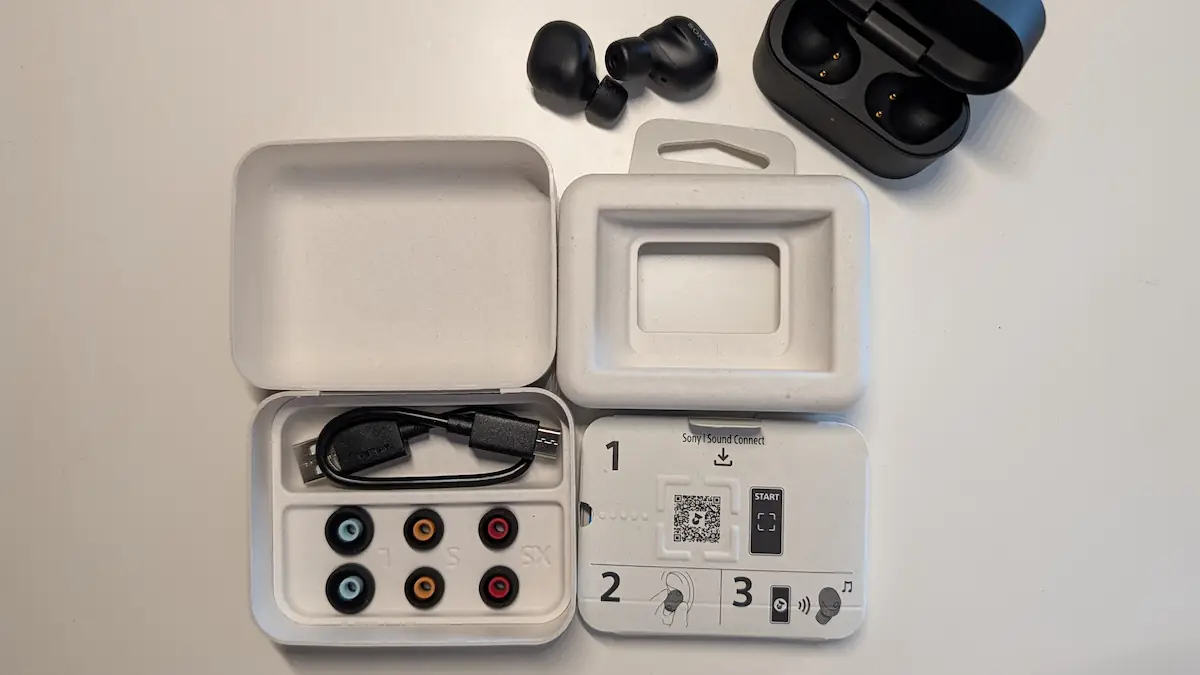 Componentes incluídos na caixa dos auriculares Sony.